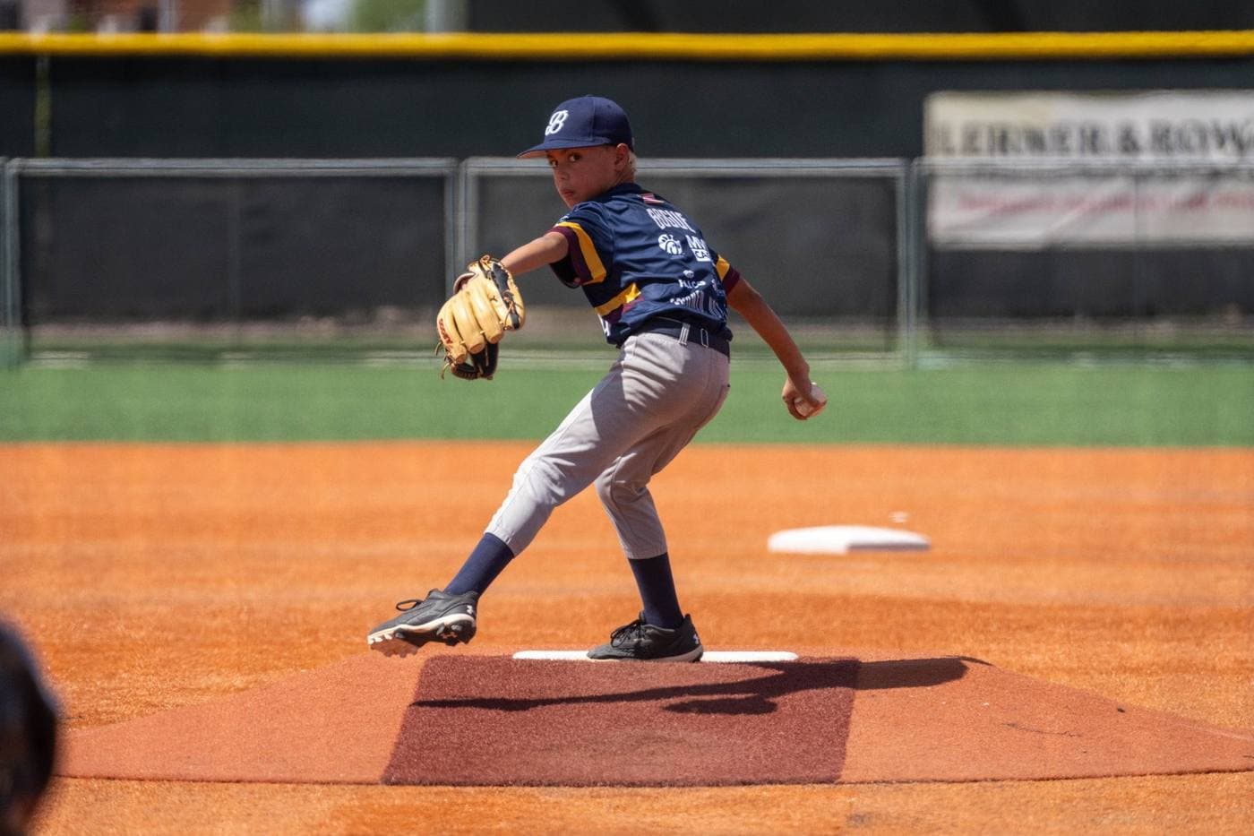 Youth baseball pitcher in game action